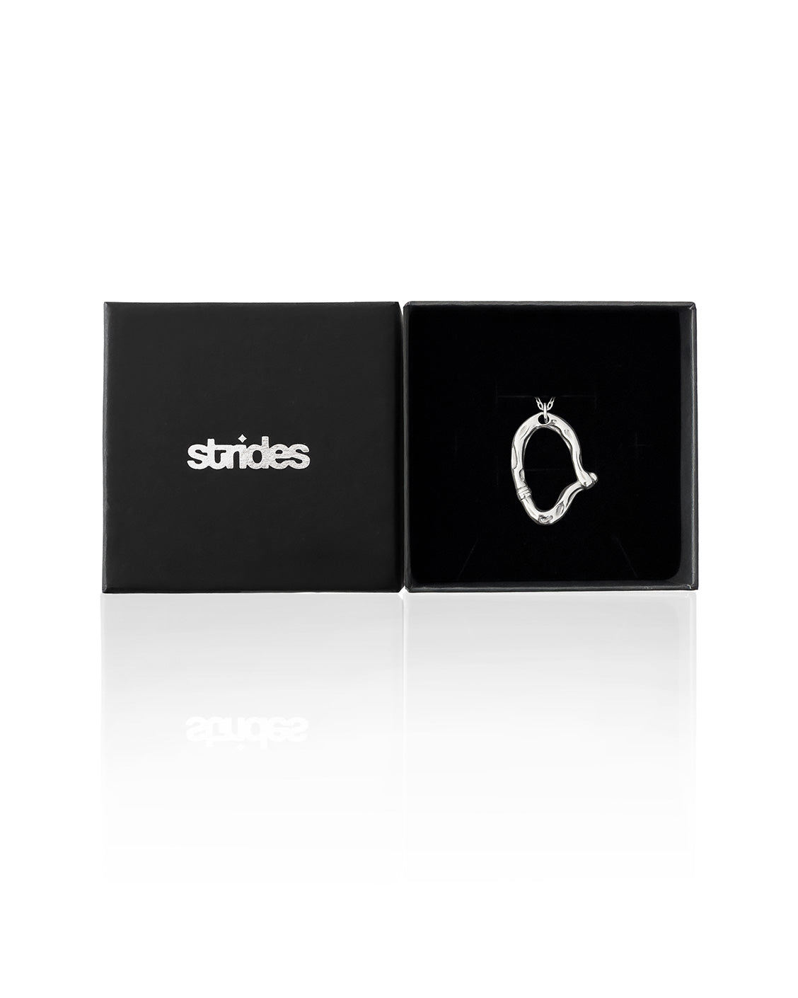 Silver necklace pendant in a black 'strides' box on a white background