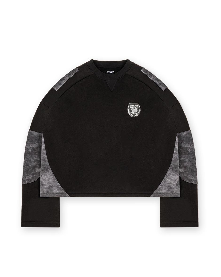 A black longsleeve crop top with alpha black camouflage patches on the sleeves and a logo print on the chest.