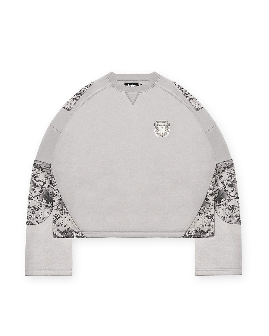 A longsleeve delta grey camouflage crop top with a boxy fit and wide sleeves, featuring a logo print on the front.