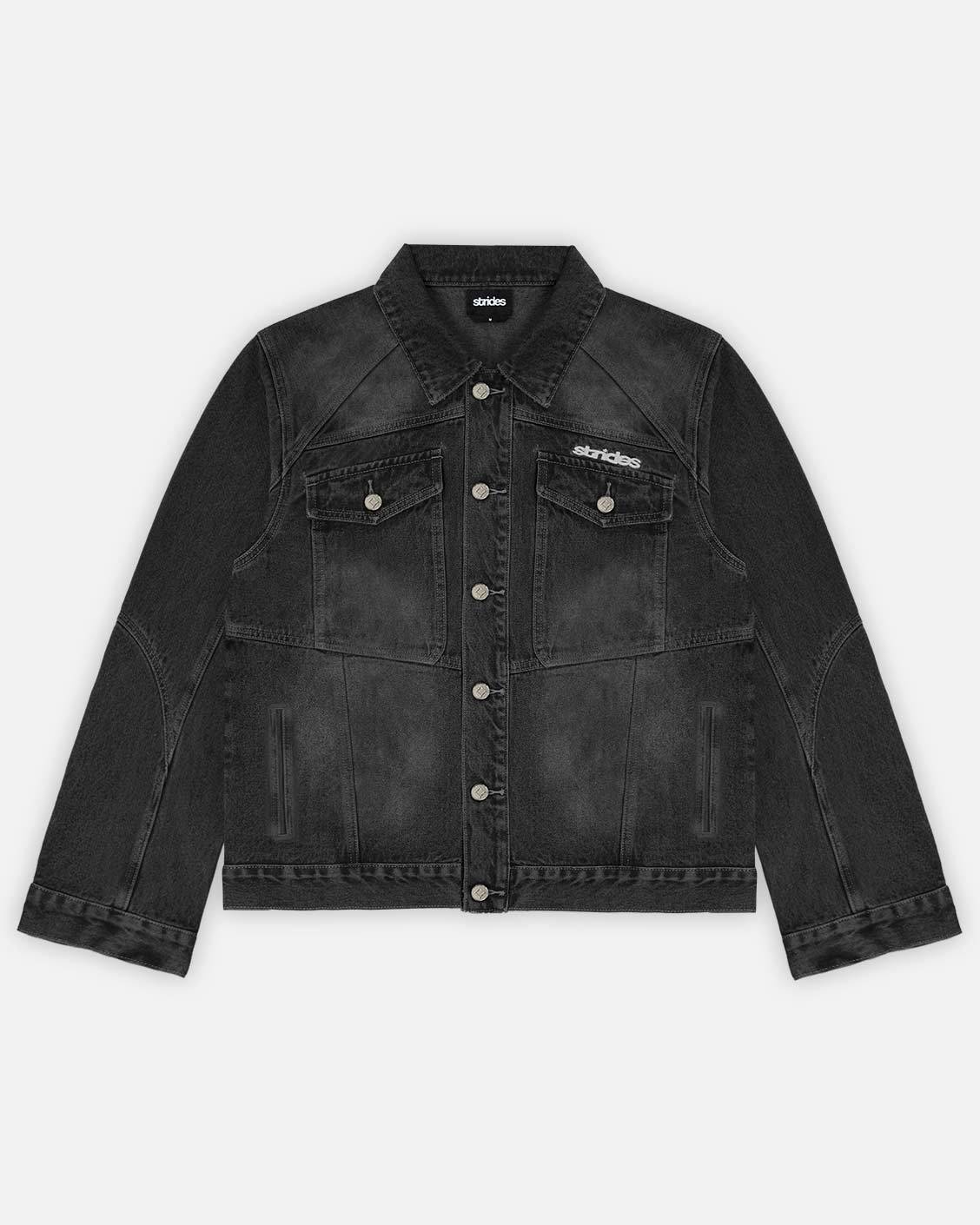 A black denim jacket with front pockets, logo embroidery and leather patch, displayed on a mannequin.