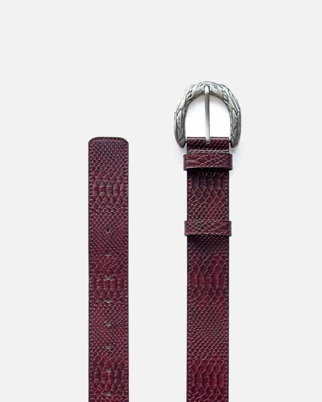 Burgundy textured leather belt with silver buckle on a white background
