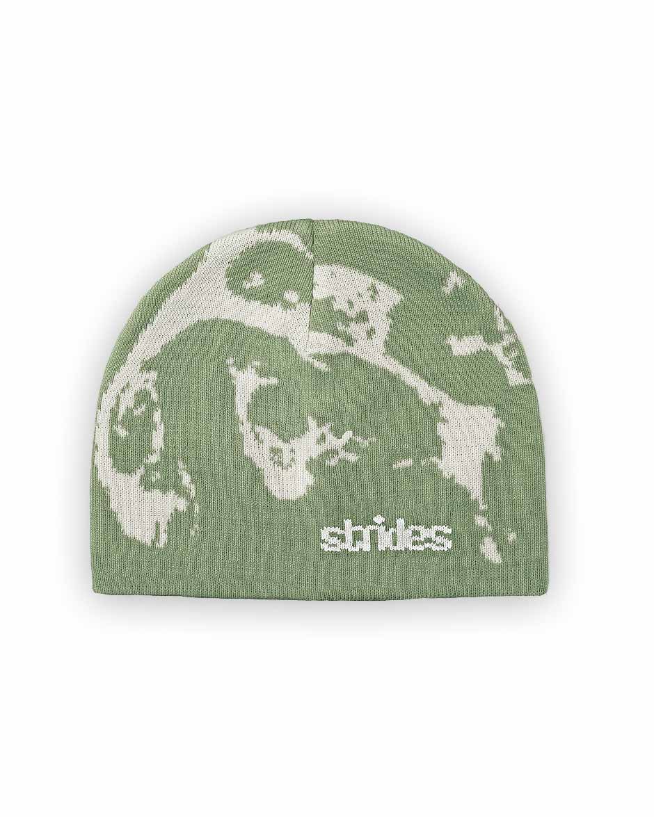 A green beanie with a text pattern that includes the word 'STRIDES' on a neutral background.