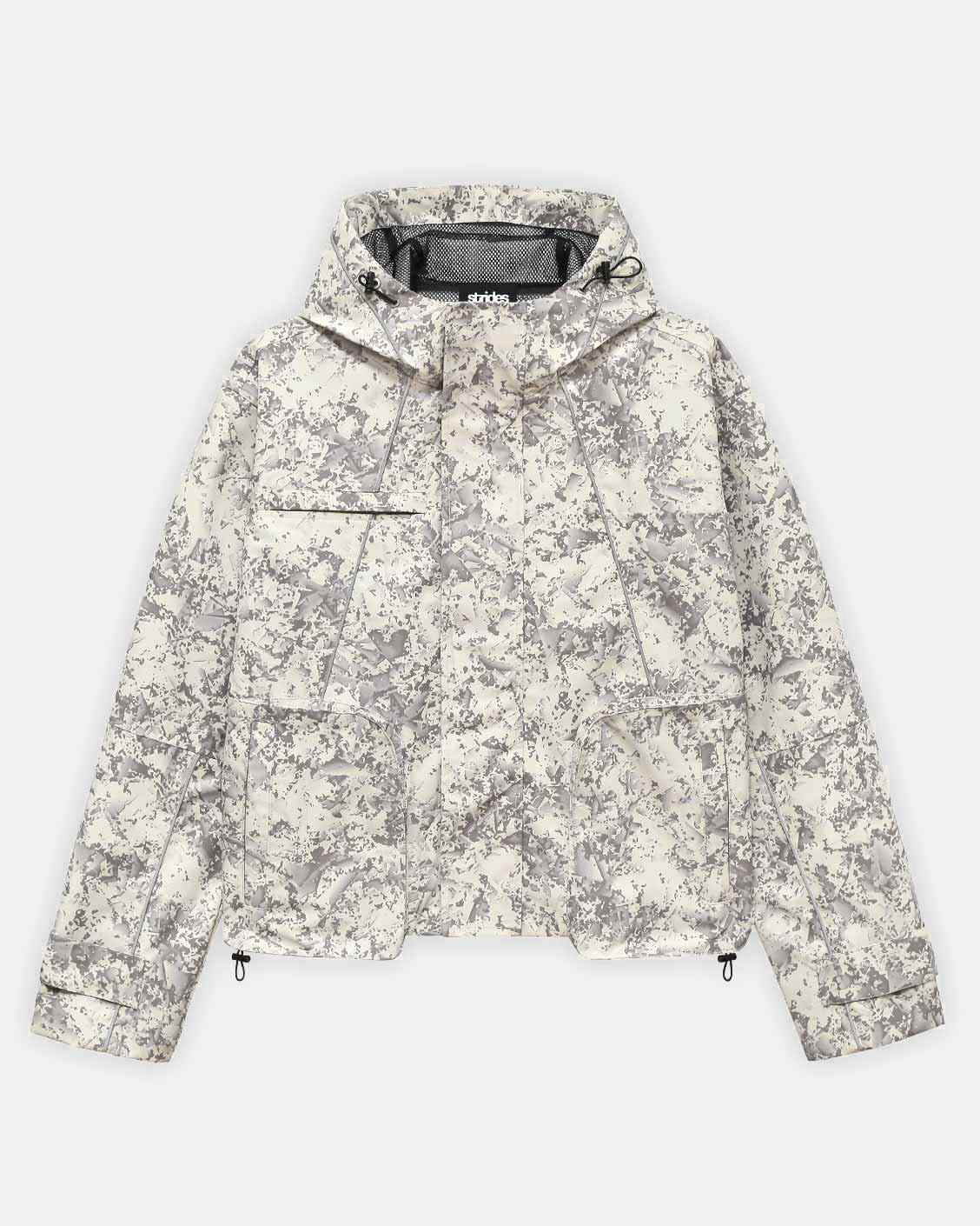 A beige camouflage tech jacket with hood, featuring reflective line details, ykk zip pockets, and adjustable sleeves.