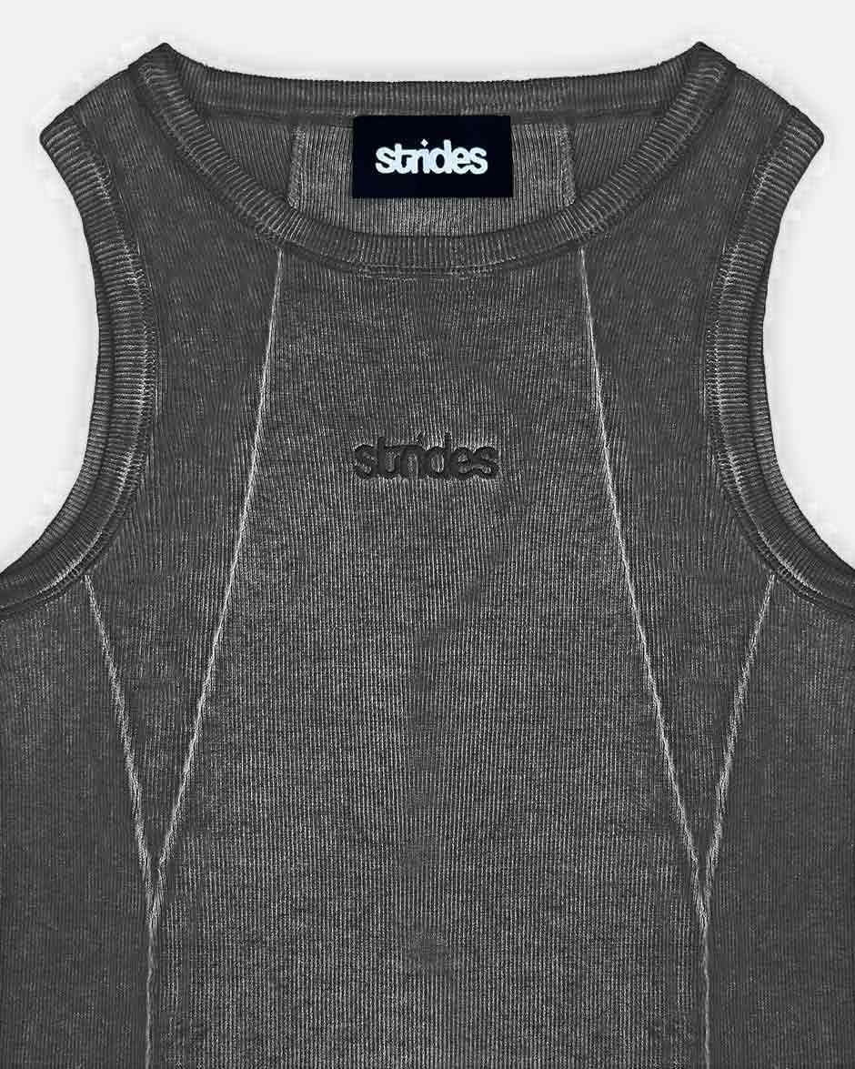 Line Tank Top Black Oil Wash, close-up detail on a light grey background