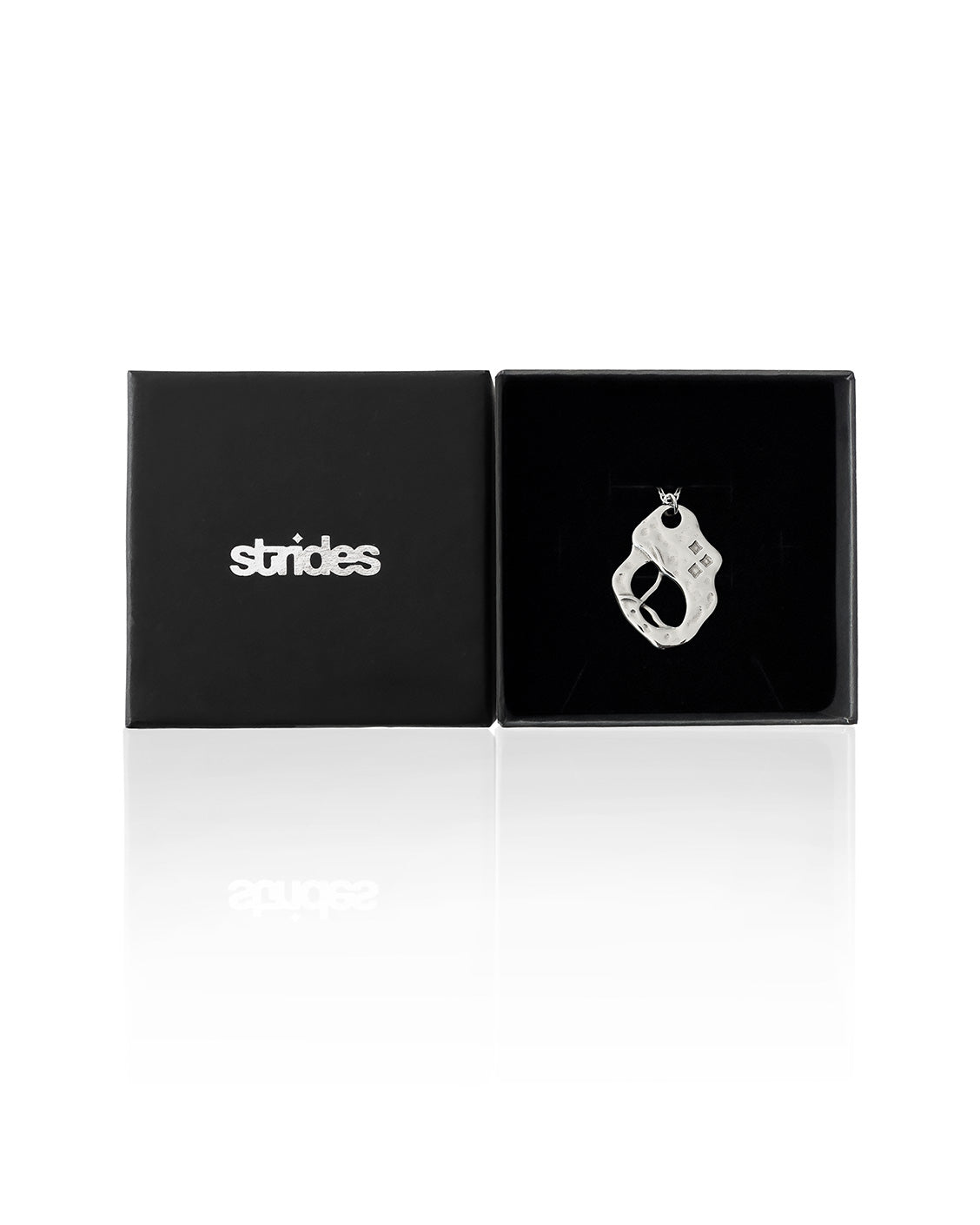 Black jewelry box with 'strides' branding and a silver ring inside on a white background