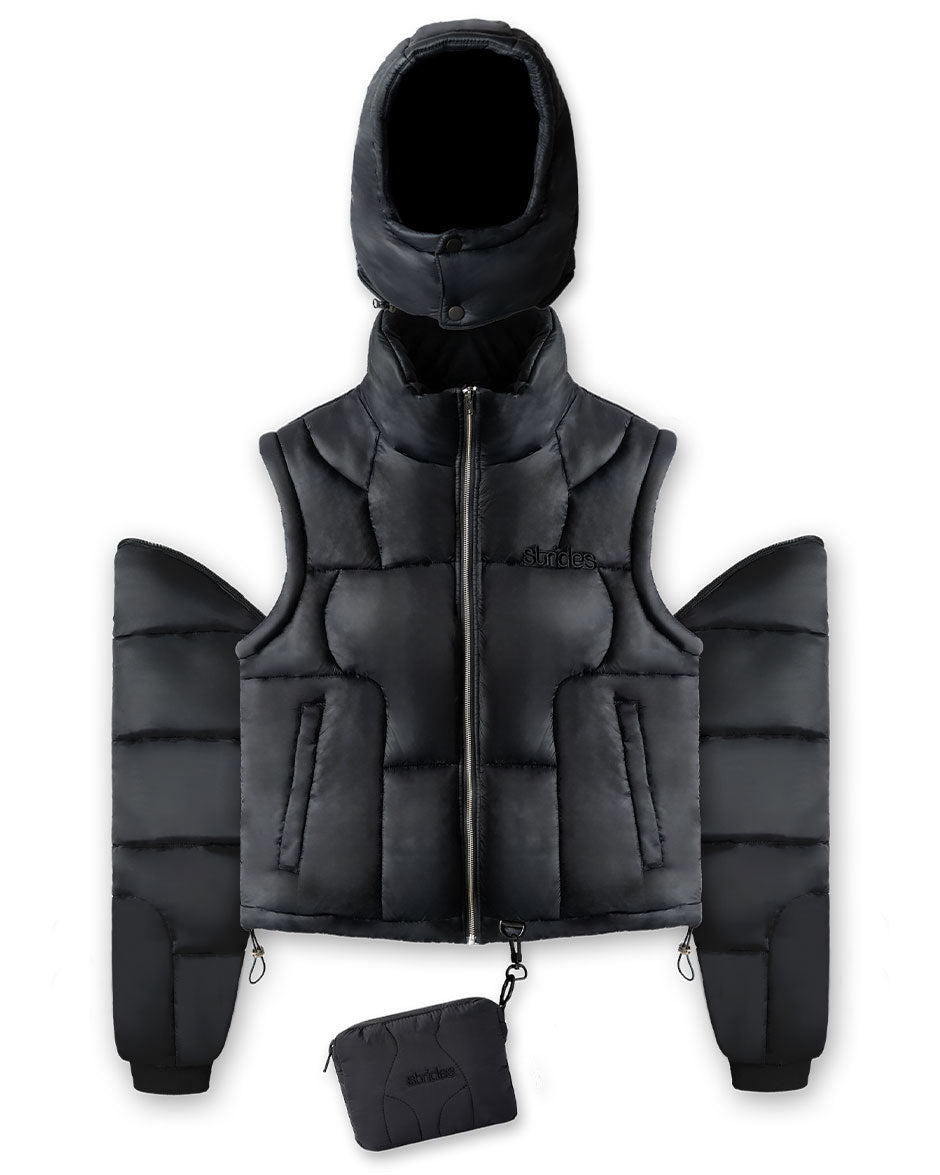 A black detachable puffer jacket with detachable arms and a hood, displayed alongside a detached arm and hood set against a white background.