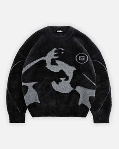 A black and gray mohair sweater with a geometric pattern and a visible brand logo on the chest.