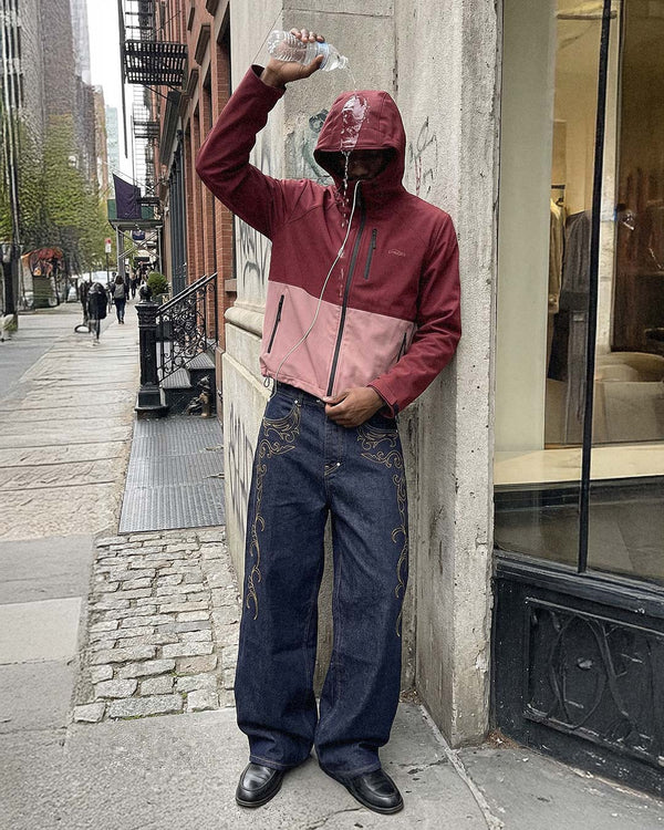 On a New York street, wearing the two-tone Gamma Rain Jacket in bordeaux