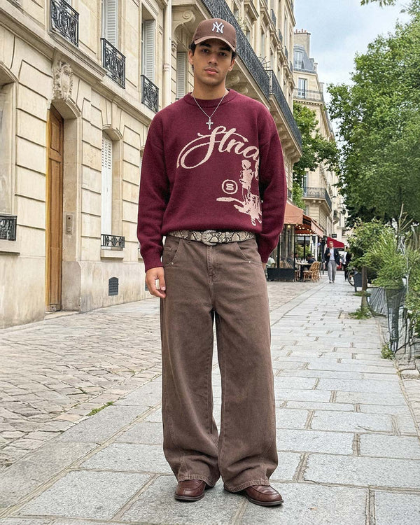 In Paris, wearing the Echoes Knit Sweater in bordeaux with brown trousers