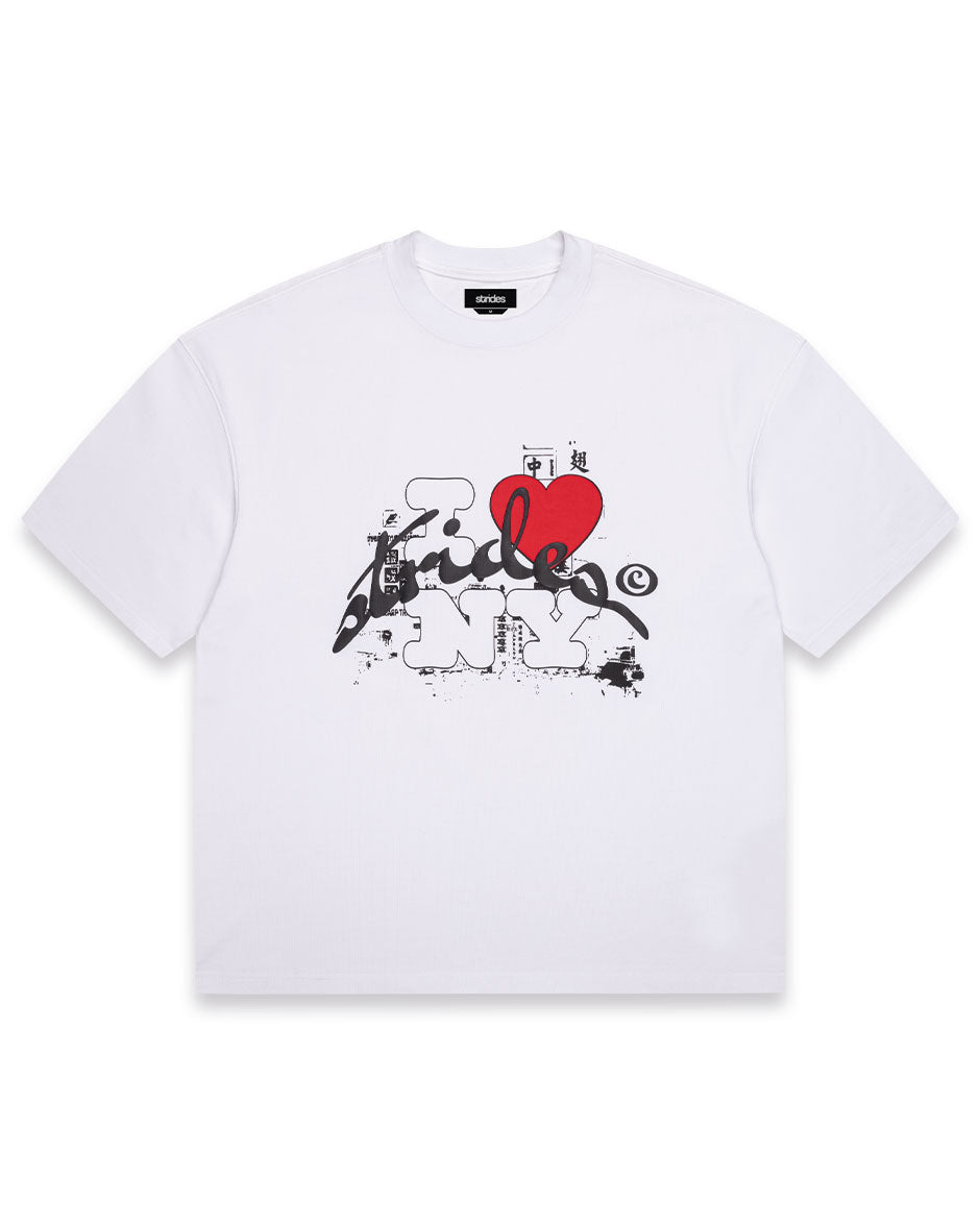 White oversized t-shirt with a puff print design featuring a red heart and various other elements, on a plain background.